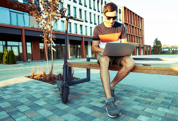 Young Man Sitting Bench Electric Scooter Mall Working Laptop — Stock Photo, Image