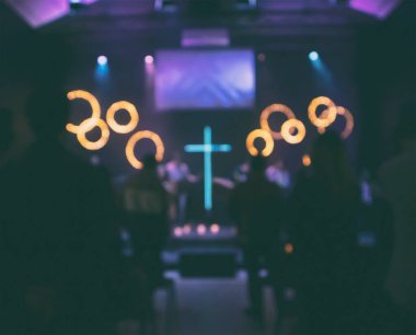 Blurred crowd of people at worship concert in the church