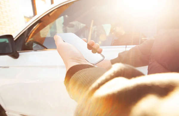 Man Holding Mobile Phone Next Door His Car Street — 스톡 사진