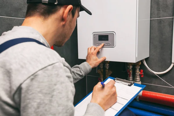 Technician Servicing Holding Clipboard Inspecting Heating System Boiler Room — Stock Fotó