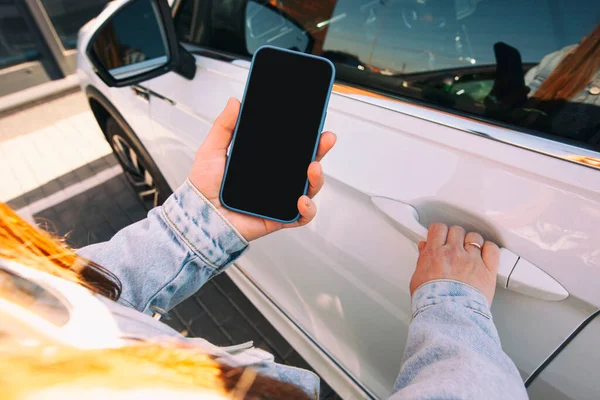 Woman Holding Mobile Phone Blank Screen Next Door Her Car — 스톡 사진