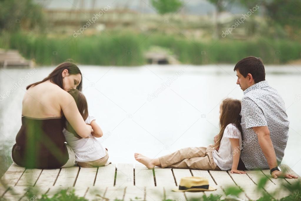 Family resting near pond