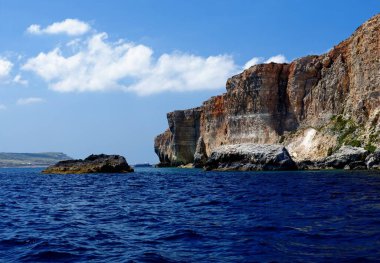 Scenic view of the sea and cliffs of Gozo island in Malta in bright day