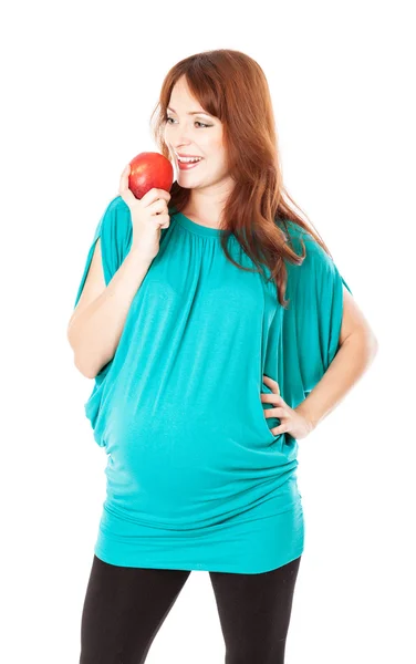 A pregnant smiling woman is holding an apple in her hand — Stock Photo, Image