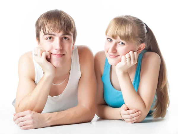 Sports couple is lying in the studio — Stock Photo, Image
