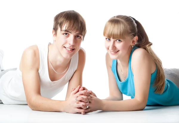 Sports couple is lying in the studio — Stock Photo, Image
