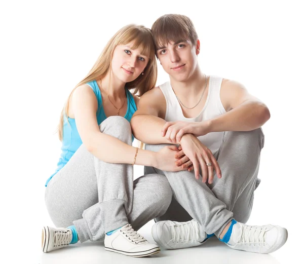 Sports couple is sitting in the studio — Stock Photo, Image
