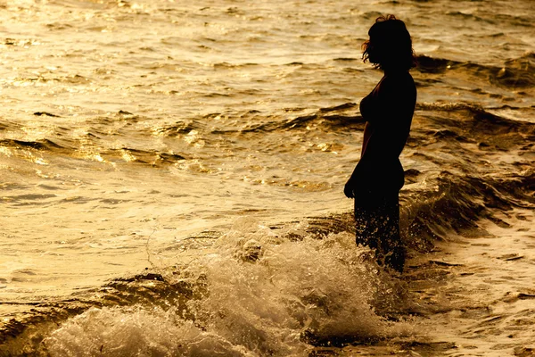 Woman is standing near the sea Stock Photo