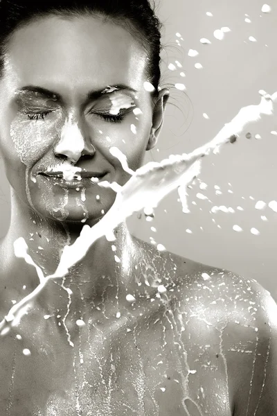 Woman in milk sprays — Stock Photo, Image