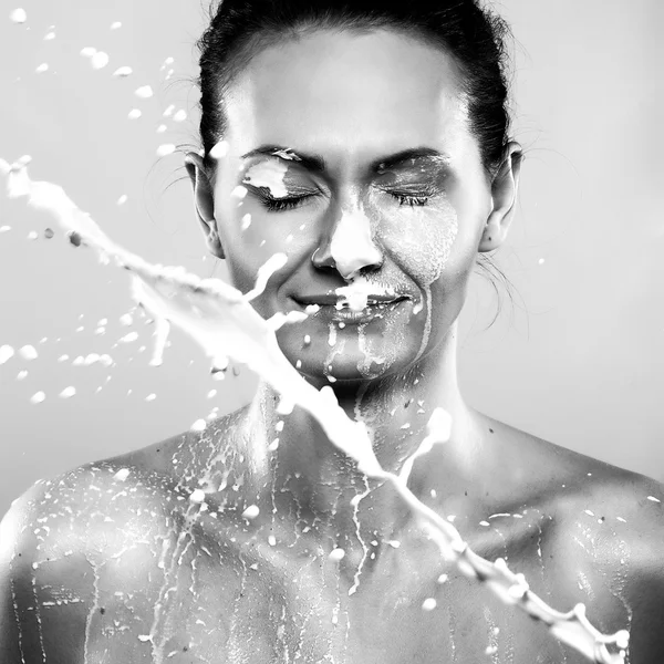 Vrouw in sprays melk — Stockfoto