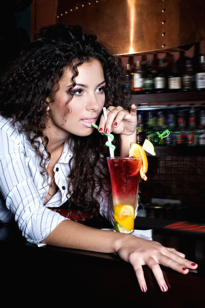 Brunette girl  with coctail in bar