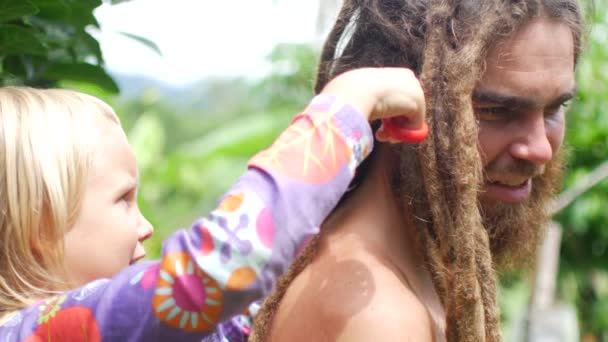 A rapariga cortou o cabelo do pai. Filha cortado daddys dreadlocks — Vídeo de Stock