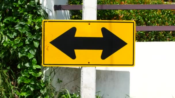 Yellow road sign. Arrow in two directions — Vídeo de Stock