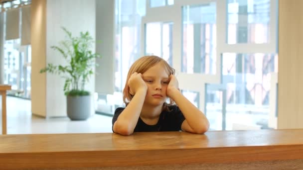 Tired Girl Eight Years Old Sits Table Props Her Head — Vídeo de Stock