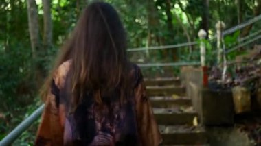 Follow me footage of a girl dressed in Asian style.