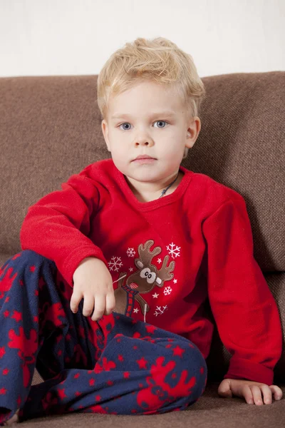 Menino no pijama no sofá — Fotografia de Stock