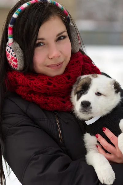 Girl with a puppy outdoors in winter — Stock Photo, Image