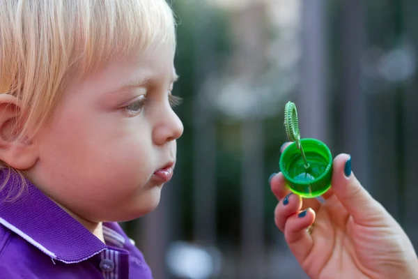 Cute baby boy blowing bubbles — Stock Photo, Image