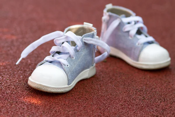 Little baby shoes on the ground — Stok Foto