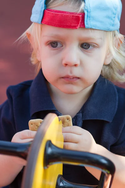 Cute blond boy with cookie — Stock Photo, Image