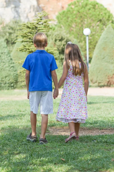 Little friends walk holding hands — Stock Photo, Image