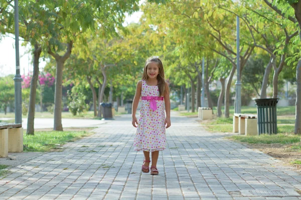 Funny little girl walking in the park — ストック写真