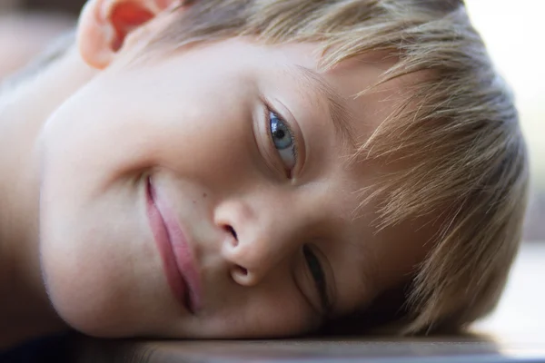 Liten pojke liggande på bordet — Stockfoto