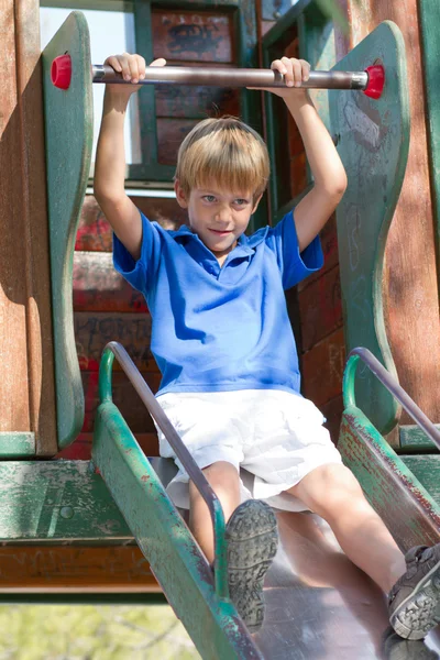 Young boy on a slide in the park — Stock Photo, Image