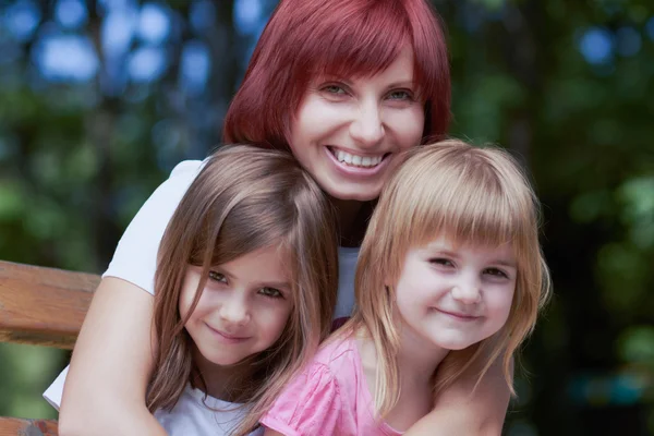 Cute little girls with their mom outdoors — Stock Photo, Image