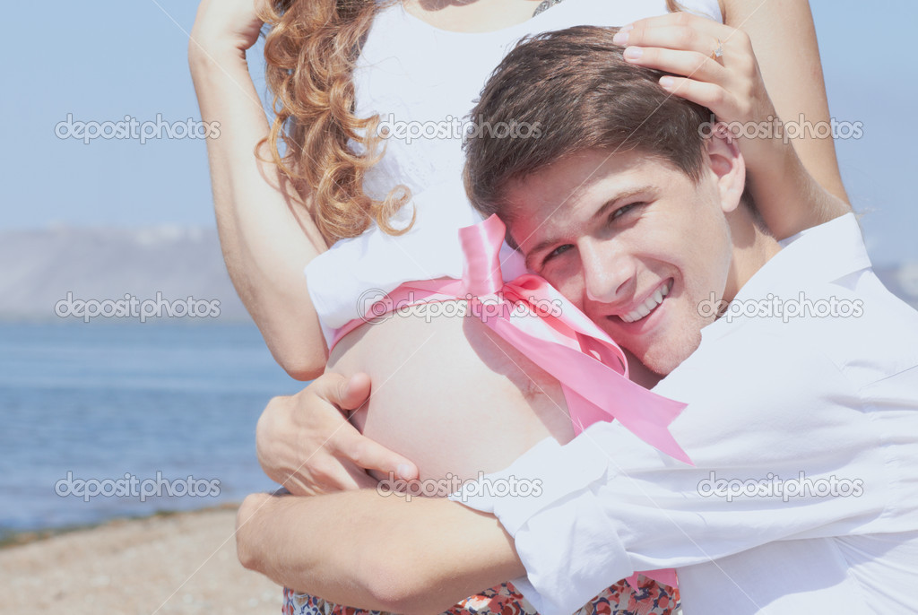 Happy young husband and his pregnant wife