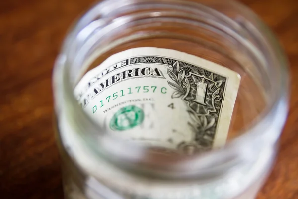 Stash of savings - one dollar in a jar — Stock Photo, Image