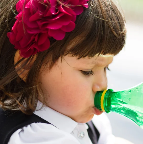 Klein meisje drinkwater uit de fles — Stockfoto