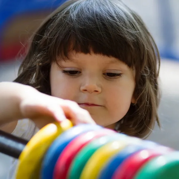 Little girl playing with count circles — Stock Photo, Image