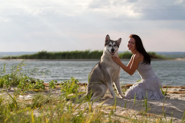 Mladá žena se psem Aljašský malamut — Stock fotografie