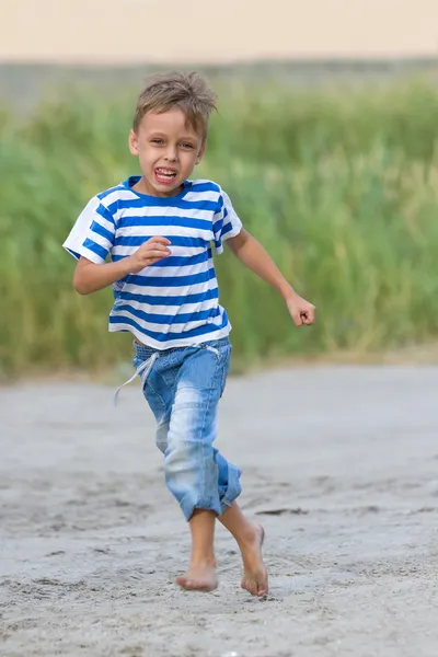 Funny little boy running outdoors — 图库照片