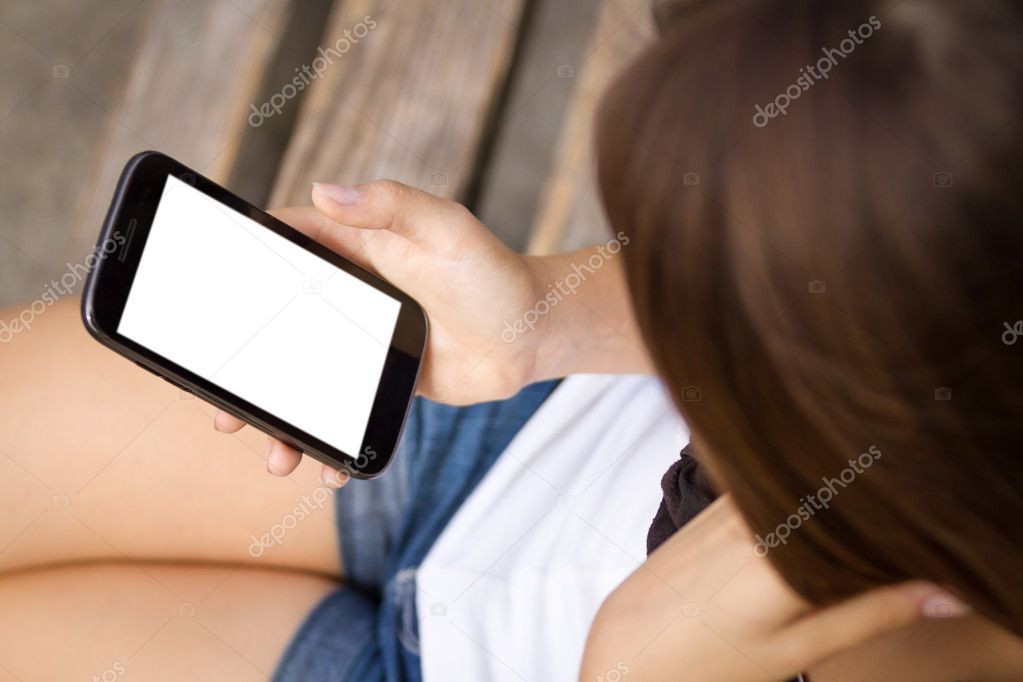 Girl holding touchscreen smartphone with white screen