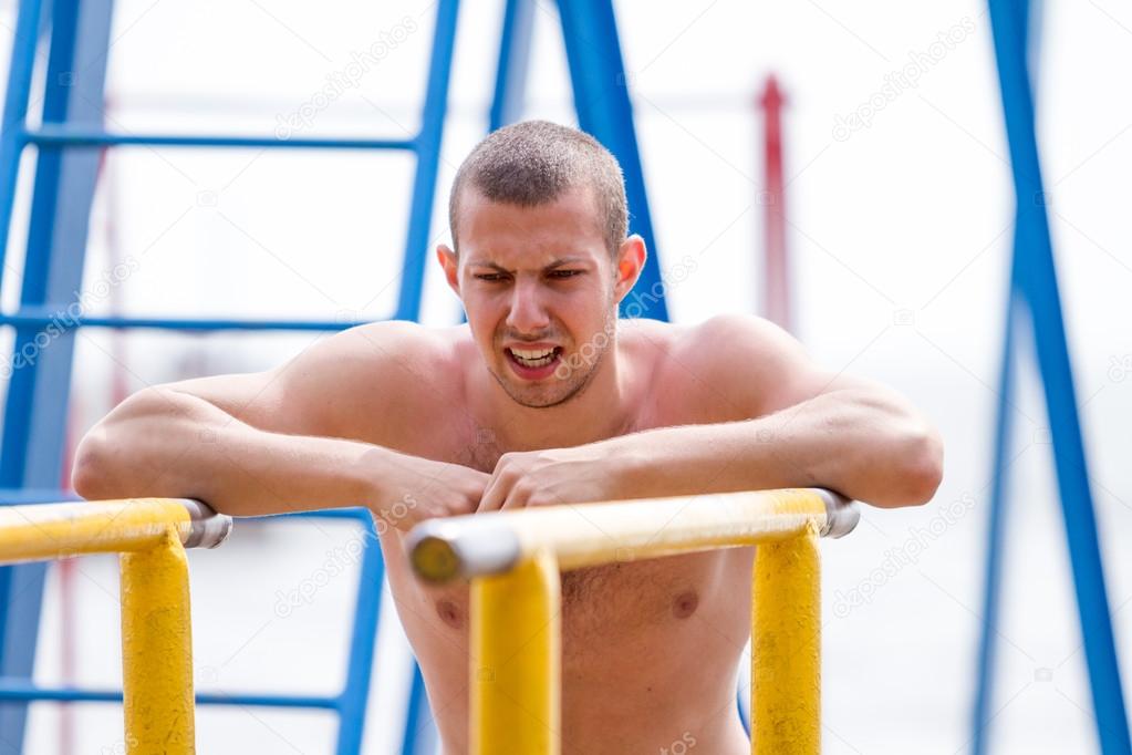 Tired young man at the bars