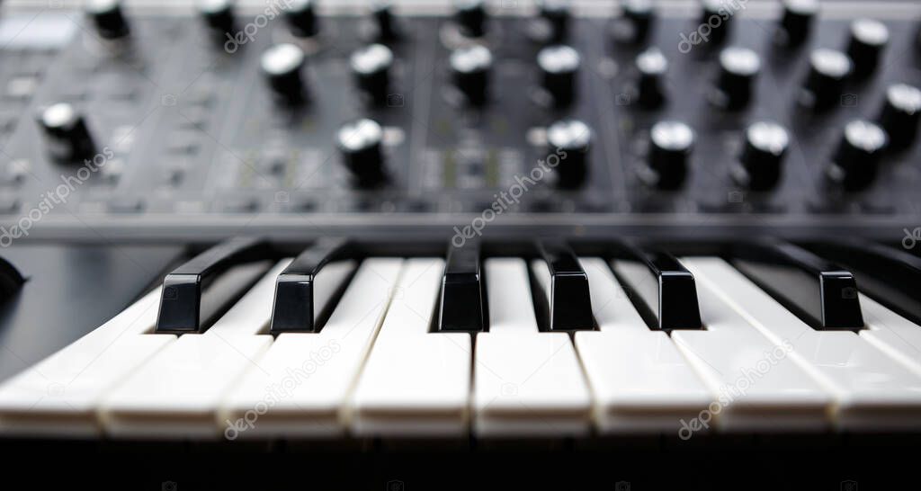 Electronic piano synthesizer keyboard. Black and white keys on analog synth device for electronic musical production