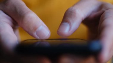 Akıllı telefonda mesaj yazmak. Adam videoyu kapatırken modern cep telefonu aygıtına kurye uygulaması ile metin yazar