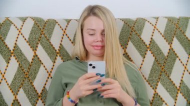 Güzel tek gözlü beyaz kadın internet haberlerini elinde modern cep telefonuyla izliyor. Aile içi şiddet kurtulan mutlu bir hayat yaşayan bir kadın. Protez sol gözü olan beyaz bir adam.
