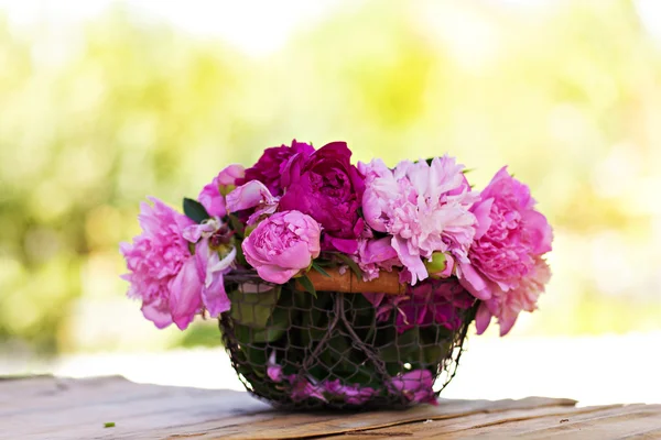 Peonies flowers in basket outdoor — Stock Photo, Image