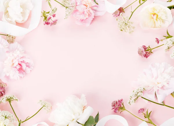 Flowers composition. Frame made of romantic pink peony flowers on pink background. Flat lay, top view — Stock Photo, Image