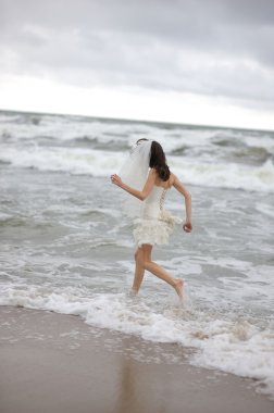 Deniz kıyısında çalışan gelin