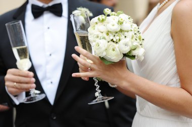 Bride and groom holding champagne glasses clipart