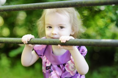 Adorable toddler girl on a green background