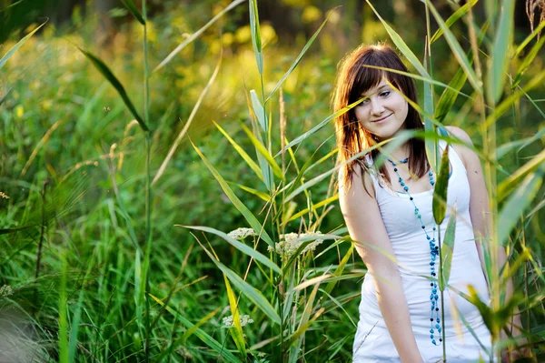 Young beautiful woman at a sunset — Stock Photo, Image