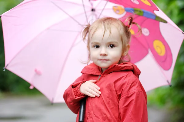 Adorable toddler girl at rainy day in autumn — Stock Photo, Image