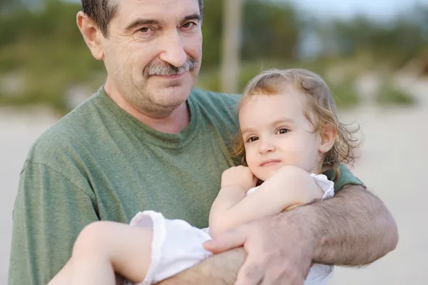 Grandfather holding his granddaughter — Stock Photo, Image