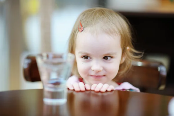 Adorable smiling toddler girl at cafe — Stock Photo, Image