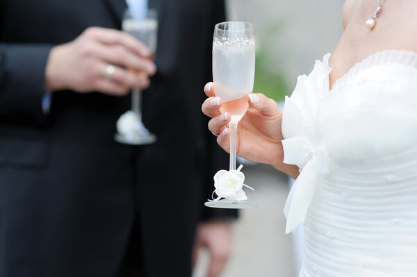 Bride and groom holding champagne glasses